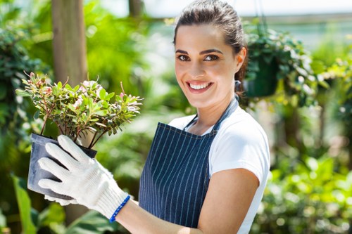 Gardener trimming a garden hedge in West Ham