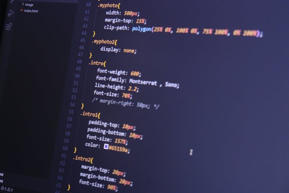 A close-up view of a computer screen displaying HTML code in a code editor. The code includes tags such as <html>, <head>, <title>, and <link>, with syntax highlighted in various colors like blue, ora